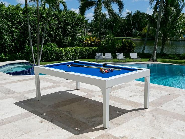 Weatherproof outdoor pool table near a swimming pool